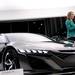 A news anchor broadcast beside the Acura NSX at the North American International Auto Show on Tuesday, Jan. 15. Daniel Brenner I AnnArbor.com